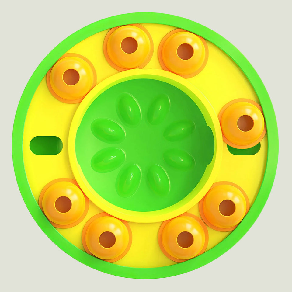 Round yellow and green toy with orange circular elements on a white background