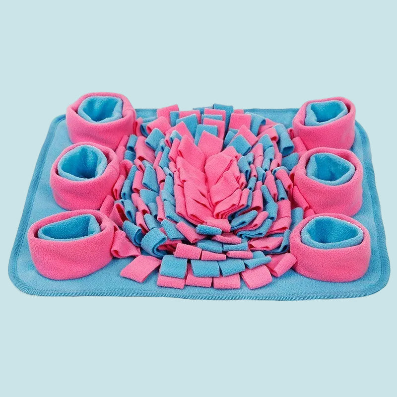 Pink and blue pet mat with rolled-up padding on a white background