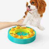 Dog playing with a colorful puzzle toy on a white background