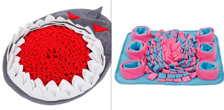Two textured mats, one shark-shaped and one with pink and blue design, on a white background.