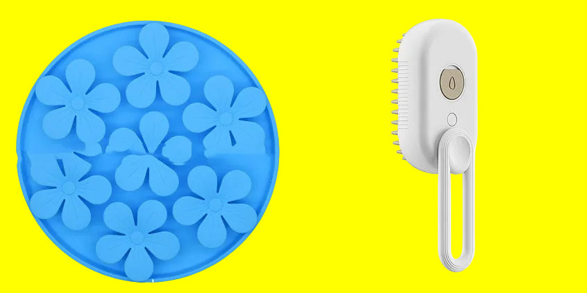 Blue flower-shaped ice cube tray and white handheld brush on a white background