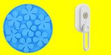 Blue flower-shaped ice cube tray and white handheld brush on a white background