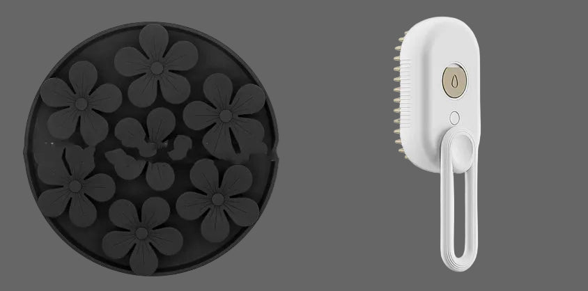 Black silicone mold with flower shapes and a white handheld cleaning brush on a white background