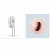 White scrubber with bristles and a pink circular object on a white background